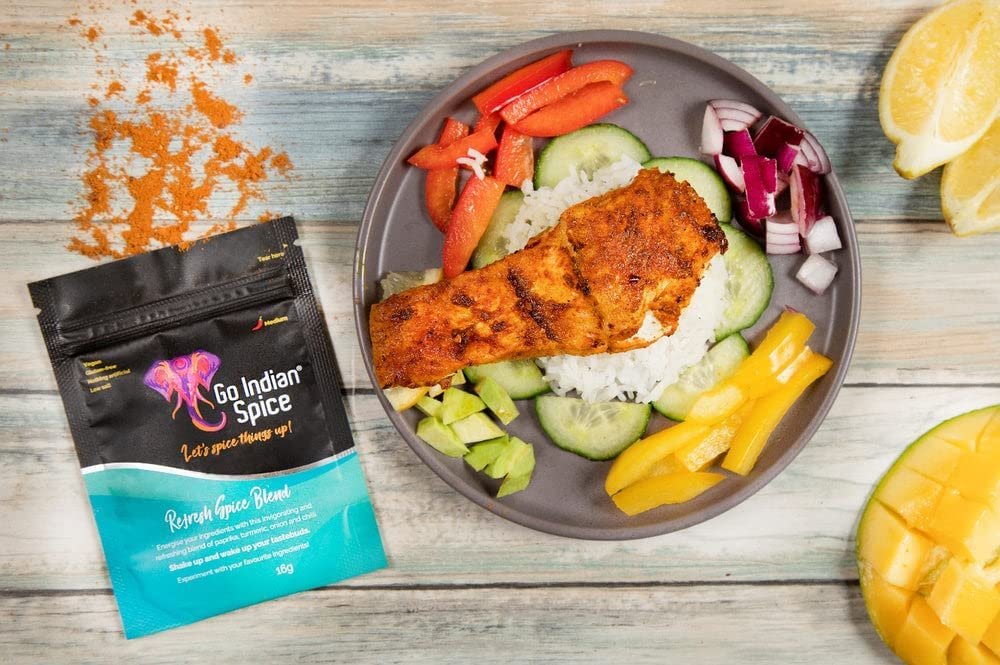 A picture of meat and vegetables on a plate next to a packet of Go Indian Spice mix